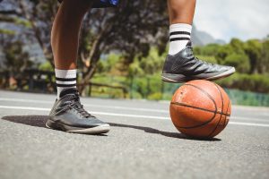 men-standing-with-one-leg-on-basketball