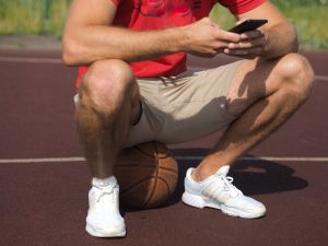 young-man-sitting-on-basketball